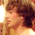 Pixelated static image of a person's face in profile with warm lighting and brown hair, displayed as a 50x50 buddy icon on a light background.