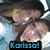 Pixelated anime-style image of two characters with dark hair and light skin, one leaning toward the other, with text overlays.