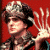A pixelated animated contact sheet showing a character with dark hair and a crown-like headpiece against a red background on the left, transitioning to green text reading "Original Icons .com" on a solid green background on the right.