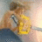 Pixelated image of a person with brown hair holding a yellow object against a soft gradient background.