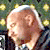 A 2x2 contact sheet of three animated frames showing a bald man in different poses against varied backgrounds, with the rightmost frame having a solid gray background.