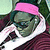 Pixelated green-skinned character with pink headband, dark clothing, and white collar in close-up view.