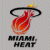 Pixelated icon of a basketball with flame-like texture, encircled by a black ring and topped with yellow sparkles, below which is blocky text reading 'MIAMI HEAT' in dark gray.