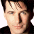 A 50x50 pixel animated contact sheet showing two frames of a buddy icon featuring a person's face on the left and green text reading "Original Icons .com" on the right against a dark background.