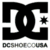 Black and white DC logo with star, 'DCSHOPE.COM' text below; alien skeleton holding microphone with 'blind' text on brown background; green heart with X symbol.