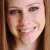 Static 50x50 pixel icon showing a close-up of a person's face with light skin tone, brown hair, and visible facial features including eyes, nose, mouth, and teeth.