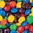 Pixelated image of colorful candy pieces with repeated text 'Chocolate is better in colors' on black background.