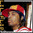 Pixelated static icon of a person wearing a red and yellow cap with dark hair, set against a black background with scattered colored pixels on the left side.