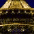 Golden pagoda with tiered roofs and ornate carvings against dark blue background, transitioning to purple and pink hues.