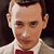 A pixelated image of a person in a white shirt and red bow tie with red text reading "I know you are but what am I?" on black background.
