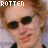 identical pixelated images showing a person with light brown hair, dark sunglasses, and a slight smile against a pale blue background