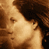 Pixelated close-up of a person's face with brown hair and warm-toned skin, rendered in low-resolution 49x49 pixels with visible dithering and pixelation effects.