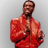 Pixelated image of a person in a red jacket with arms crossed against a gray background.
