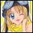A pixelated anime-style character with blonde hair and blue eyes winking, wearing a yellow top and gray headband, next to "Anime IM" text on black background.