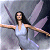 A pixelated figure with outstretched arms stands against a gray background, wings visible behind them.