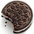 A chocolate sandwich cookie with a bite taken out, next to a glass of milk and a cartoon cookie face with pink tongue.