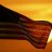 A pixelated image shows a dark, striped object against an orange-yellow gradient background with horizontal bands.