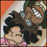 Two cartoon characters lie close together; one wears glasses and a cap, the other has dark hair and pink clothing.