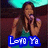 A woman with long dark hair sings into a microphone, wearing a sleeveless green top against a blurred background.