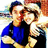 Two pixelated figures embrace; one wears a blue shirt with visible text, the other dark clothing against a blurred background.