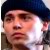 Pixelated close-up of a person wearing a dark blue cap, with visible skin tones and partial facial features.