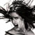 Static grayscale buddy icon of a person with voluminous dark hair and an open mouth, rendered in low-resolution pixel art style against white background.