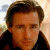 A split-screen image with a pixelated portrait on the left and green text on a dark background on the right.