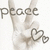 A pixelated hand making a peace sign with fingers, holding a heart-shaped key against a white background.