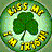 Green four-leaf clover at center surrounded by yellow flowers on green background with light circular glow.