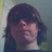Pixelated image of a person with long dark hair on left, green text on black background on right reading "I Love Brandon<3".