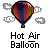 Pixelated hot air balloon icon with multicolored stripes and a basket containing a white skull-like figure, displayed on gray background with clouds.