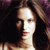 A pixelated close-up of a person with long dark hair, light skin, and red lips, set against a dark background with purple accents.