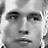 Static grayscale buddy icon depicting a pixelated human face with neutral expression, visible eyes and nose, and no text or additional elements.