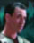 Pixelated image of a figure with reddish-brown hair against teal and dark green background, no visible text or distinct clothing details.