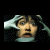 A pixelated image with a person holding their head, blue text reading DON'T GO TO and red SLEEP!, and a small blurry figure on the right.