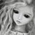 Black-and-white animated icon of a doll-like figure with long wavy hair, showing subtle facial expression changes across frames.