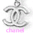 A silver-toned interlocking CC logo with a loop at the top, displayed across three with pink text below each reading 'chanel', 'is', and 'love'