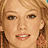 Pixelated image of a person with light brown hair and blue eyes, alongside stylized text reading 'Hilary Duff' in green on white background.