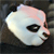 A pixelated close-up of a stylized animal head with a single visible eye, rendered in light blue and pink tones against a dark background.