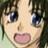 Pixelated close-up of a character's face with large blue eyes, light skin, and a wide open mouth showing pink tongue and teeth.
