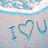 A beach scene with waves and sand, featuring 'I ❤️ U' text in blue outline on the left side.