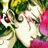 Anime character with green hair and red eyes, wearing a white outfit against pink and green background.