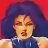 Pixelated image of a person with dark hair against a red background, wearing a blue top with white accents.