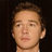 Pixelated image of a person with brown hair against a dark background, next to pink pixelated text reading 'oh shia<3 what a babe!' on a black background.