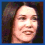 Four pixelated show a person with long dark hair in sequential facial expressions: neutral, open-mouthed speaking, smiling widely, and laughing