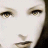 Static close-up of a stylized female face with visible eyes, nose, and mouth on a light background.