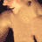 Pixelated static image of a shirtless male figure with light skin tone, partial torso and shoulder visible against dark background.