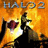 Halo 2 promotional artwork with orange-yellow flames, a soldier silhouette holding a weapon, and an Xbox console with controller on white background.
