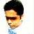 Pixelated portrait of a person with short dark hair, wearing sunglasses and a light blue shirt against a white background.