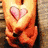 Animated sequence showing a character in orange clothing with a pink heart on the chest, transitioning from a full-body view to a close-up of the lower body.